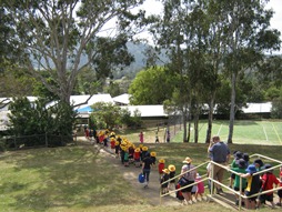 Students walking on path down hill